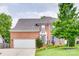 Charming two-story red brick home with a well-manicured lawn and lush landscaping at 3725 Leela Palace Way, Fort Mill, SC 29708