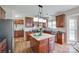 This kitchen offers wood floors, cherry cabinets, granite countertops, stainless steel appliances, and a kitchen island at 3725 Leela Palace Way, Fort Mill, SC 29708