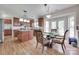 Eat-in kitchen features wood floors, cherry cabinets, granite countertops, island, and stainless steel appliances at 3725 Leela Palace Way, Fort Mill, SC 29708