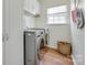 The laundry room includes washer, dryer, white cabinets, and a window that provides natural light at 3725 Leela Palace Way, Fort Mill, SC 29708