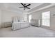 Spacious main bedroom with trey ceiling, ceiling fan, carpet floors, and large windows for ample natural light at 3725 Leela Palace Way, Fort Mill, SC 29708