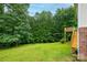 Private backyard with mature trees features a wooden deck accessible by stairs on the side of the house at 4059 Caitlins Way, Hickory, NC 28602