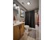 Bathroom featuring neutral tones has a tub with shower, wood vanity, framed mirror, and tiled flooring at 4059 Caitlins Way, Hickory, NC 28602