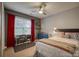 Cozy bedroom with natural light features a ceiling fan, desk by the window, and unique furnishings at 4059 Caitlins Way, Hickory, NC 28602