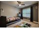 Comfortable bedroom featuring a ceiling fan, window, and carpeted floors, offering a cozy retreat at 4059 Caitlins Way, Hickory, NC 28602