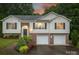 Charming two-story home featuring a brick facade, vinyl siding, and an attached two-car garage at 4059 Caitlins Way, Hickory, NC 28602