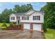 Inviting two-story home featuring a brick facade, two-car garage, and manicured landscaping at 4059 Caitlins Way, Hickory, NC 28602