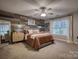 Serene main bedroom featuring a decorative wood wall, a ceiling fan, and large windows for natural light at 4059 Caitlins Way, Hickory, NC 28602