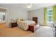 Cozy bedroom with a ceiling fan, wood furniture, floral comforter, green curtains, and bright natural light at 415 Glandon Ct, Fort Mill, SC 29708