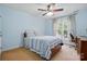 Comfortable bedroom with a ceiling fan, light blue walls, and natural light from a window at 415 Glandon Ct, Fort Mill, SC 29708