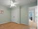 Simple bedroom featuring a ceiling fan, neutral carpet and mint green walls, and a large closet at 415 Glandon Ct, Fort Mill, SC 29708