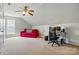 Spacious bonus room with a bright red sofa, desk, and a window with natural light at 415 Glandon Ct, Fort Mill, SC 29708