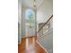 Bright foyer featuring hardwood floors, a staircase with white railings, and a large arched window above the front door at 415 Glandon Ct, Fort Mill, SC 29708