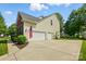 Spacious two-car garage with a concrete driveway and well-maintained landscaping, plenty of parking space at 415 Glandon Ct, Fort Mill, SC 29708