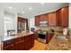 Bright kitchen with stainless steel appliances, ample cabinet space, granite counters, and a tile backsplash at 415 Glandon Ct, Fort Mill, SC 29708