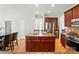 Open concept kitchen with dark wood cabinets, island with seating, stainless steel appliances, and a dining area at 415 Glandon Ct, Fort Mill, SC 29708