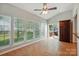 Sunroom featuring bright windows, tile floors, backyard views and access to the deck at 415 Glandon Ct, Fort Mill, SC 29708