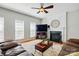 Cozy living room features a fireplace with mantel, hardwood floors, and an area rug at 415 Glandon Ct, Fort Mill, SC 29708