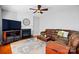 Comfortable living room with fireplace, hardwood floors and large leather couch at 415 Glandon Ct, Fort Mill, SC 29708