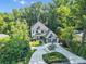 Stunning aerial view of a two-story home with a lush landscape and circular driveway nestled in a serene setting at 4211 Tangle Dr, Charlotte, NC 28211