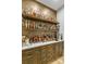 Custom bar area with wooden cabinets, open shelving and stylish decor at 4211 Tangle Dr, Charlotte, NC 28211