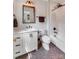 A stylish bathroom featuring a white vanity, bronze fixtures and a mosaic tile floor at 4211 Tangle Dr, Charlotte, NC 28211