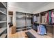 Walk-in closet features custom shelving, lots of storage, and wood flooring at 4211 Tangle Dr, Charlotte, NC 28211
