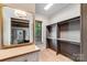 Spacious walk-in closet featuring custom shelves and a window for natural light at 4211 Tangle Dr, Charlotte, NC 28211
