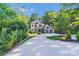 Charming two-story home with a well-manicured front yard and a circular driveway surrounded by lush greenery at 4211 Tangle Dr, Charlotte, NC 28211