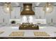 Close-up of the kitchen island with modern pendants, professional range, and white backsplash at 4211 Tangle Dr, Charlotte, NC 28211