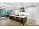 Modern kitchen boasts an island with seating and a stylish range hood at 4211 Tangle Dr, Charlotte, NC 28211