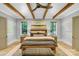 Cozy main bedroom with wood-beamed ceilings, neutral tones, and natural light at 4211 Tangle Dr, Charlotte, NC 28211
