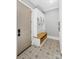 Mudroom with hall tree and storage; stylish gray tiled floor with white trim at 4211 Tangle Dr, Charlotte, NC 28211