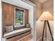 Cozy reading nook with a built-in bench, wood paneled wall, and a backyard view at 4211 Tangle Dr, Charlotte, NC 28211