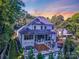 Stunning two-story home showcasing an outdoor entertainment area with pool, hot tub, and elegant screened porch at 4211 Tangle Dr, Charlotte, NC 28211