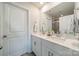 Bright bathroom features double sinks, a large mirror, and white cabinets and drawers at 4439 Millennium Ave, Charlotte, NC 28217