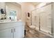 Clean bathroom featuring a glass-enclosed shower and white vanity at 4439 Millennium Ave, Charlotte, NC 28217