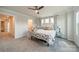 Cozy bedroom features a ceiling fan, three windows, and neutral decor with a relaxing atmosphere at 4439 Millennium Ave, Charlotte, NC 28217