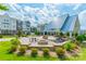 Outdoor lounge area with a central fire pit and patio seating, surrounded by townhouse exteriors at 4439 Millennium Ave, Charlotte, NC 28217