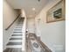 Inviting foyer featuring wood floors, stairs, and elegant decor, setting a welcoming tone at 4439 Millennium Ave, Charlotte, NC 28217