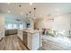 Open-concept kitchen with a center island, dining area, and adjacent living room at 4439 Millennium Ave, Charlotte, NC 28217