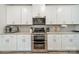 Modern kitchen with stainless steel appliances and elegant white cabinetry at 4439 Millennium Ave, Charlotte, NC 28217