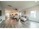 Open floor plan showcasing a seamlessly connected living room and kitchen with modern wood flooring at 4439 Millennium Ave, Charlotte, NC 28217