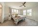 Bright main bedroom featuring a ceiling fan and a well decorated queen bed, providing relaxation at 4439 Millennium Ave, Charlotte, NC 28217