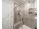 Modern tiled shower with glass door includes a shower head and bench seat at 4439 Millennium Ave, Charlotte, NC 28217