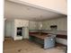 Spacious kitchen features white cabinets, a large island, and stainless steel appliances at 4622 Serenity Woods Ct, Charlotte, NC 28216