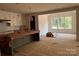 Kitchen with island and view into the breakfast nook with large windows and plenty of light at 4622 Serenity Woods Ct, Charlotte, NC 28216