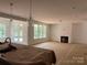 Open living room with fireplace and French doors, leading to a backyard, enhancing the living space at 4622 Serenity Woods Ct, Charlotte, NC 28216