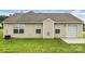 Backyard with a well-maintained lawn and a neutral colored house at 4714 Adamshire Ave, Concord, NC 28025