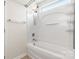 Clean bathroom with a shower-tub combo, complete with white tile and storage shelves at 4714 Adamshire Ave, Concord, NC 28025